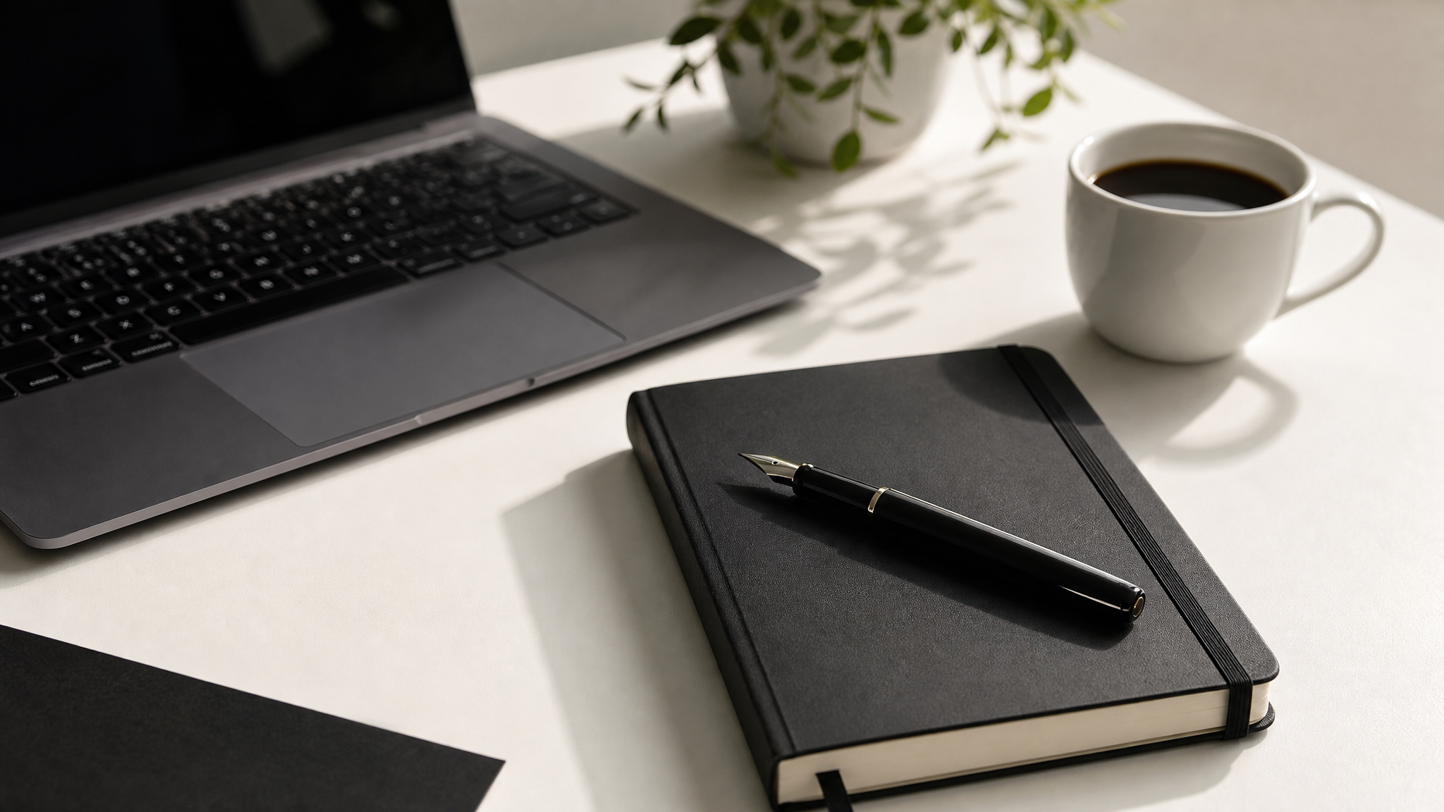 Professional workspace with laptop and notebook